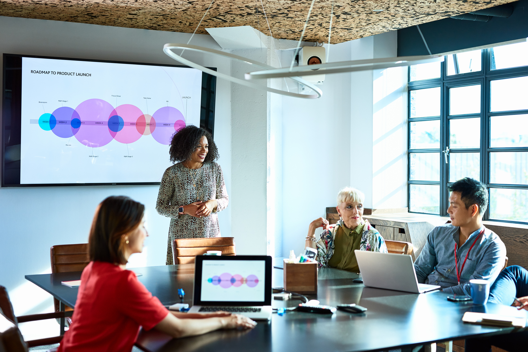 attractive businesswoman heads strategy meeting in board room