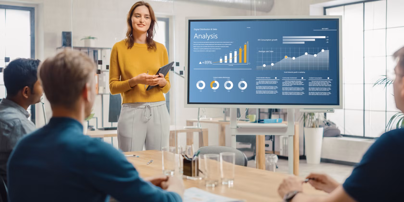 woman standing in front of presentation in meeting room
